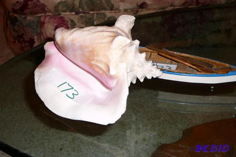 conch shell and little wooden boat &nbsp...