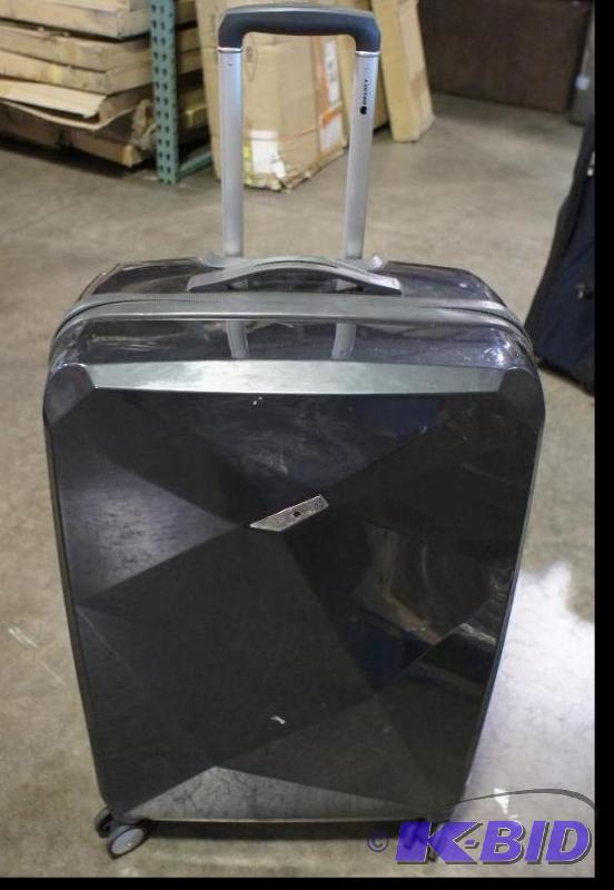 lot 5 image: Delsey Luggage Bag  Hard Case. Gray in color...