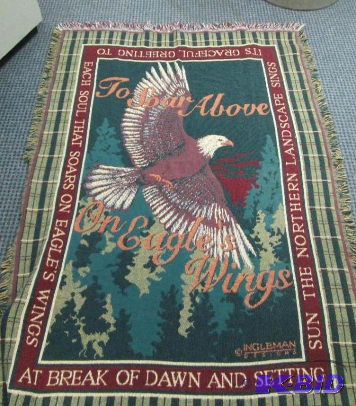 A Decorated blanket with eagle and saying on...