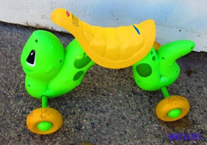 lot 94 image: Kids rider shaped like a green worm...