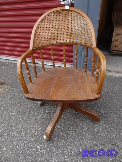 lot 21 image: Vintage wood office chair. Wicker back is loo...