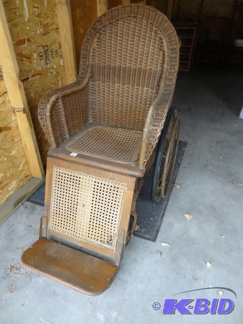 lot 23 image: Vintage wheel chair. Metal frame. Seat is woo...