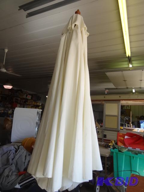 lot 76 image: Patio umbrella with cast iron base...