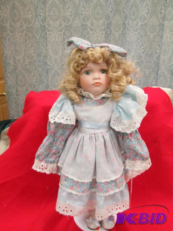 A little girl in a dress and come with stand...