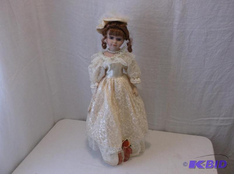 Beautiful porcelain doll on stand measuring 2...