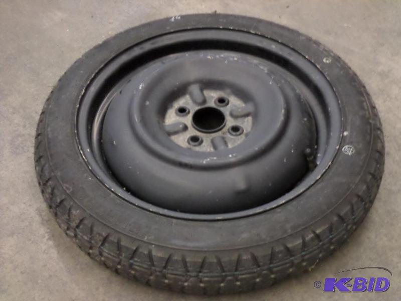 lot 44 image: Unused 4-Lug 1257016 Spare Tire...