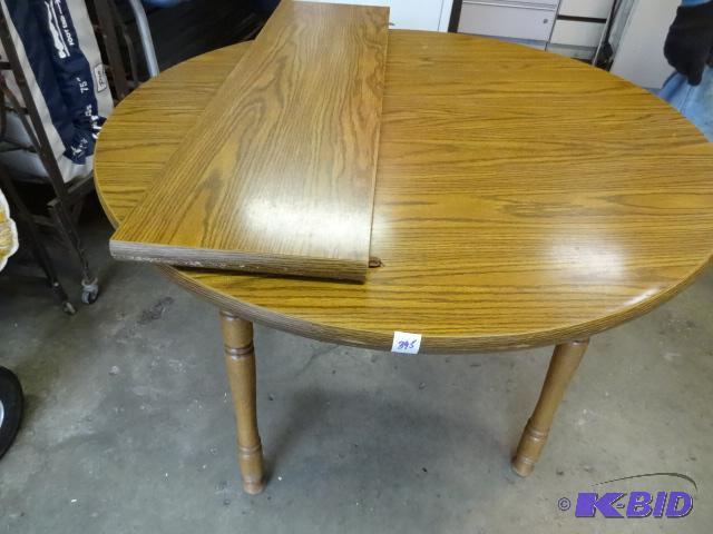 lot 395 image: 42" round kitchen table. Comes with 1 le...