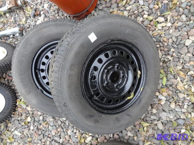 lot 53 image: P19570R13 tires. 5 hole rims. Excellent trea...