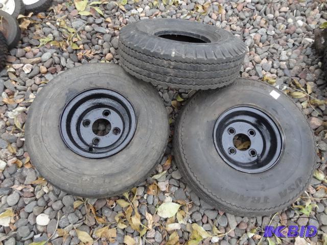 lot 54 image: 5.70-8 tire and 4 hole rim. Qty 2...
