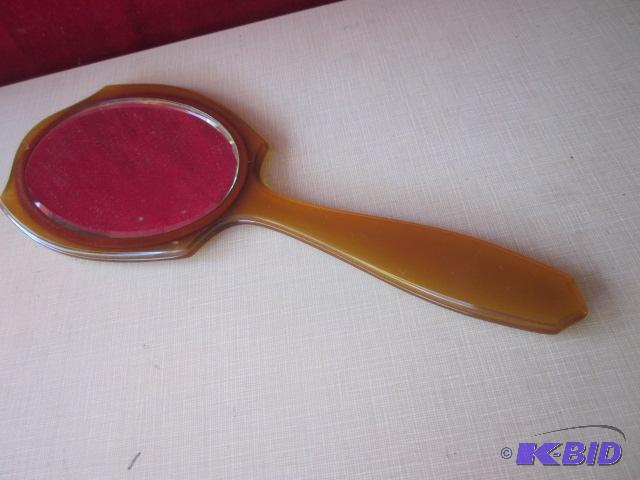 lot 64 image: Large 10 inch bakelite hand mirror....