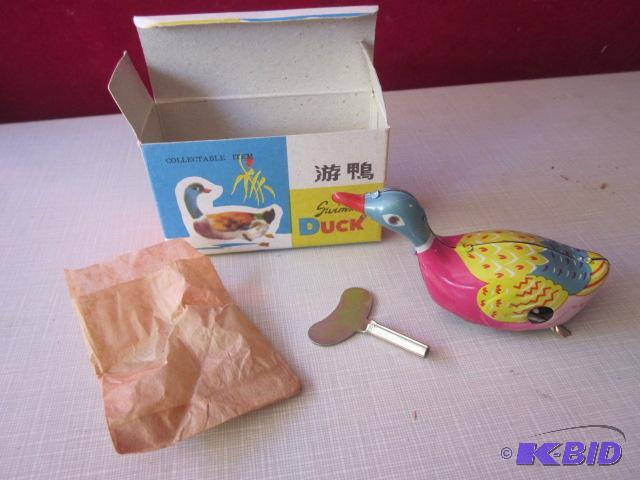 lot 69 image: Vintage tin wind up toy duck....
