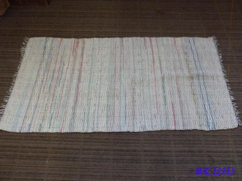 lot 122 image: Nice rag rug that measures 26" x 49"...