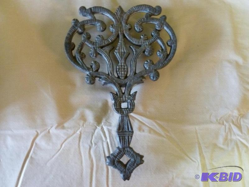 lot 24 image: Large cast iron hot pan trivet that measures ...