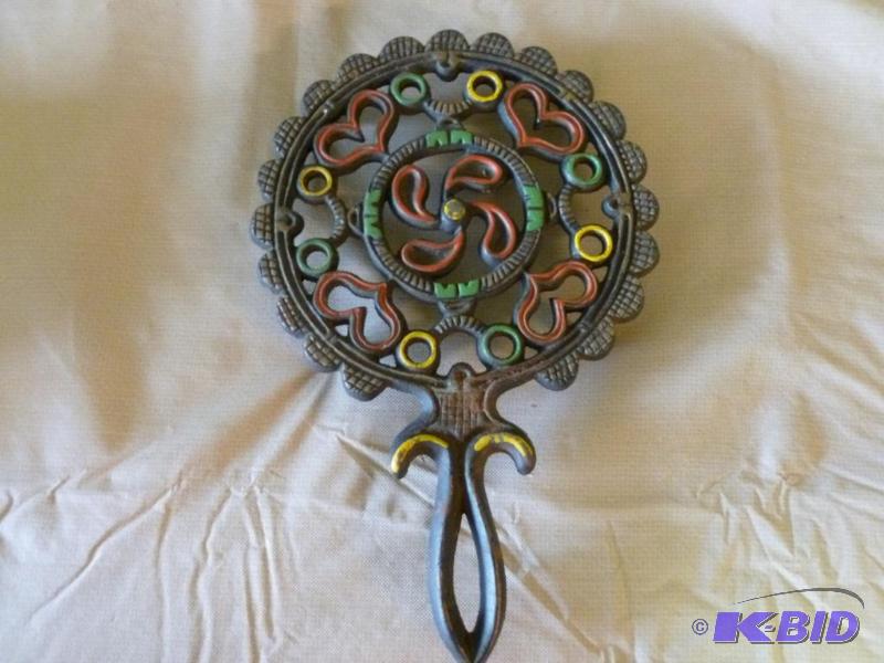 lot 25 image: Large cast iron hot pan trivet that measures ...