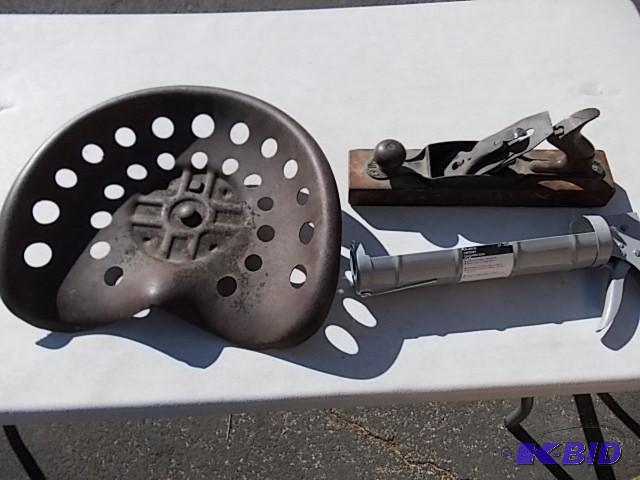 lot 72 image: Tractor Seat, Hand Plane, Large Caulking Gun...