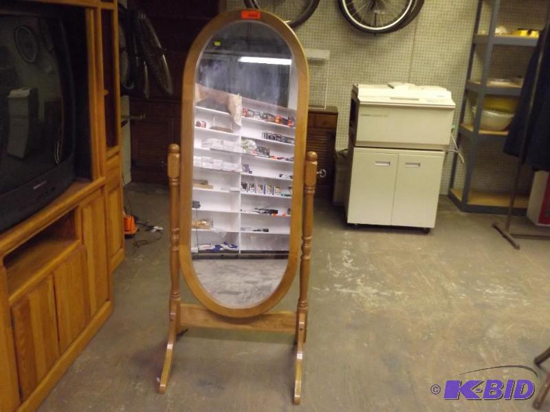Mirror on wood stand. 58 tall x 26 wide....