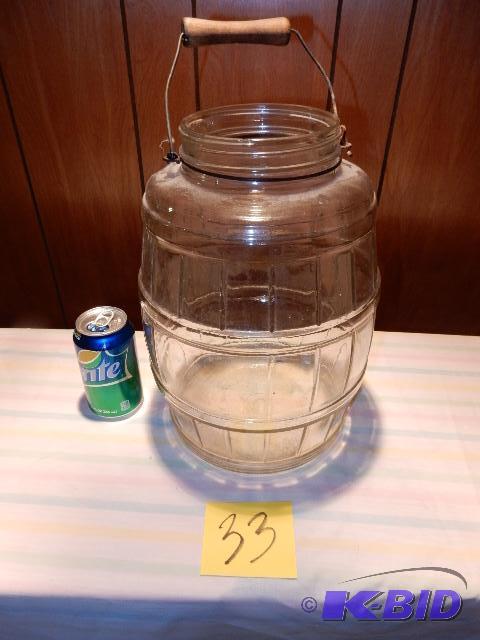 lot 33 image: Large clear glass jar with handle.. Approx 16...