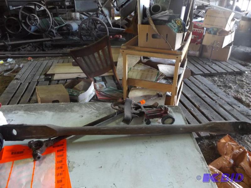 toy tractor, one old rusted skate, wooden pol...