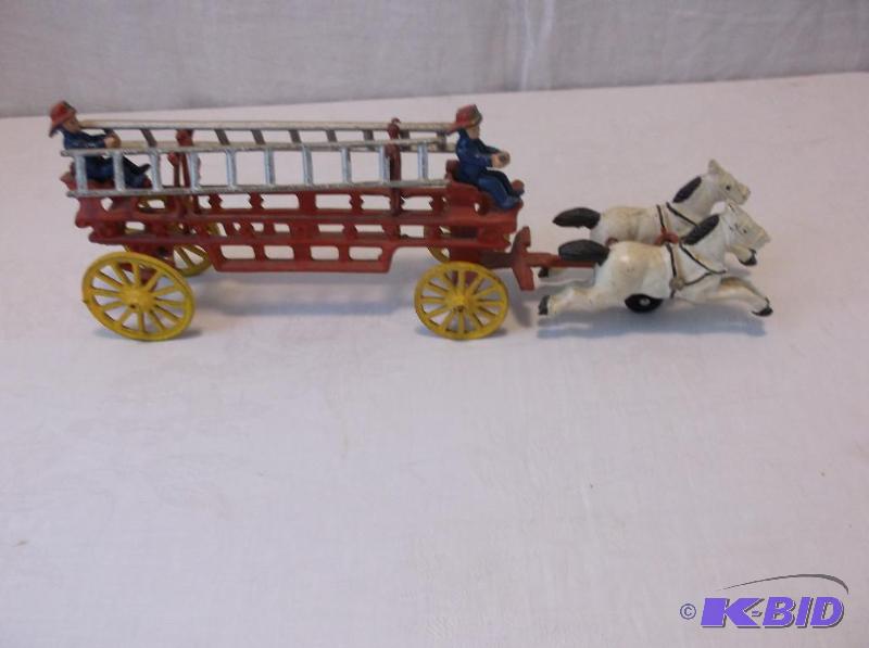 lot 27 image: Vintage cast iron toy fire wagon measuring 2 ...