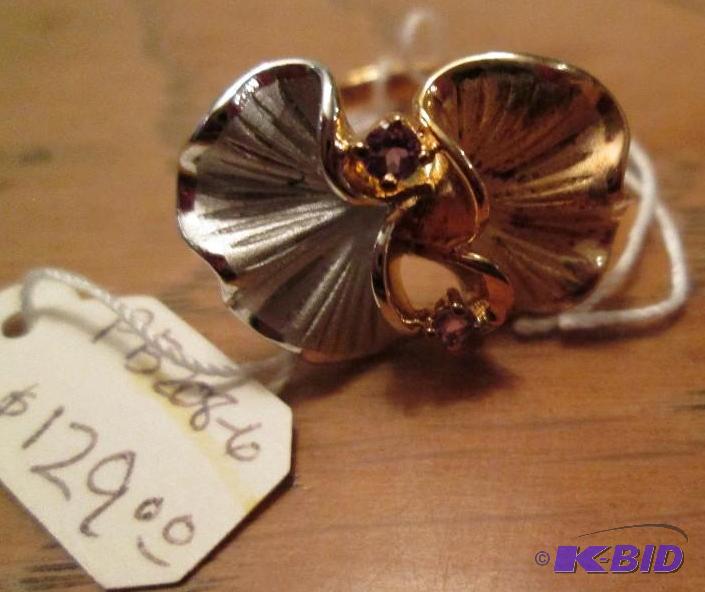 lot 35 image: Gold and silver colored ring with small amyth...