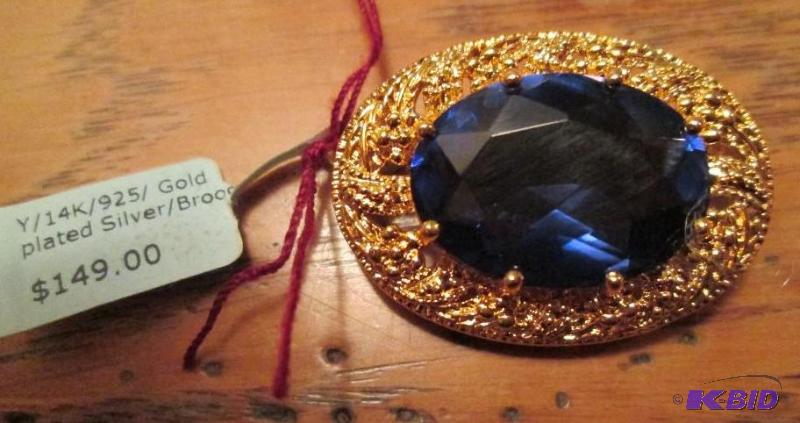 lot 56 image: 14k gold plated brooch with blue stone...