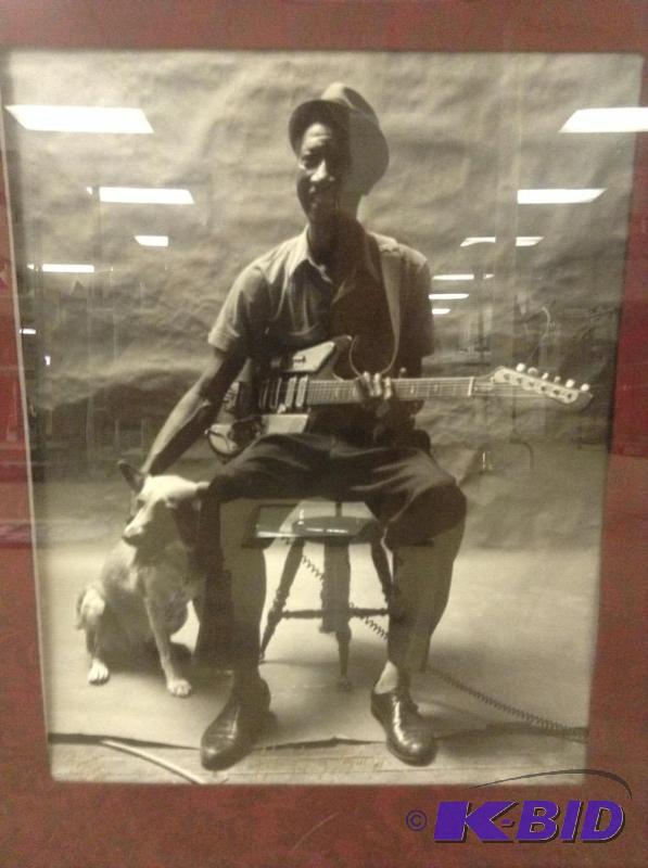 lot 29 image: Framed Picture of Blues Musician with His Guitar and Dog