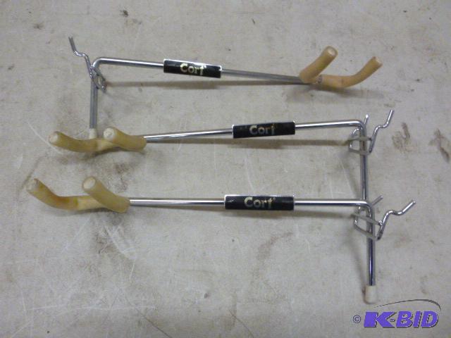 lot 80 image: Three Cort Wall Guitar Hangers...