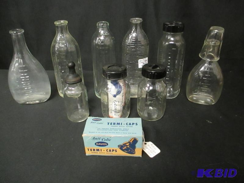 lot 105 image: Group of 9 Glass Baby Bottles and Caps