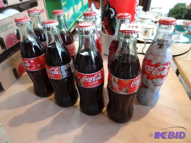 lot 313 image: 9 Holiday Collector Coke Bottles...