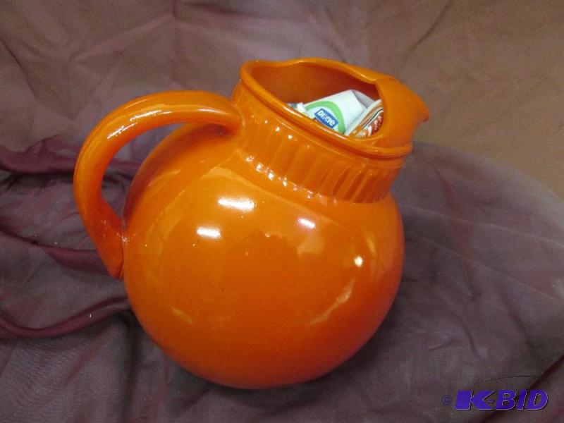 lot 130 image: Tilted orange pitcher...