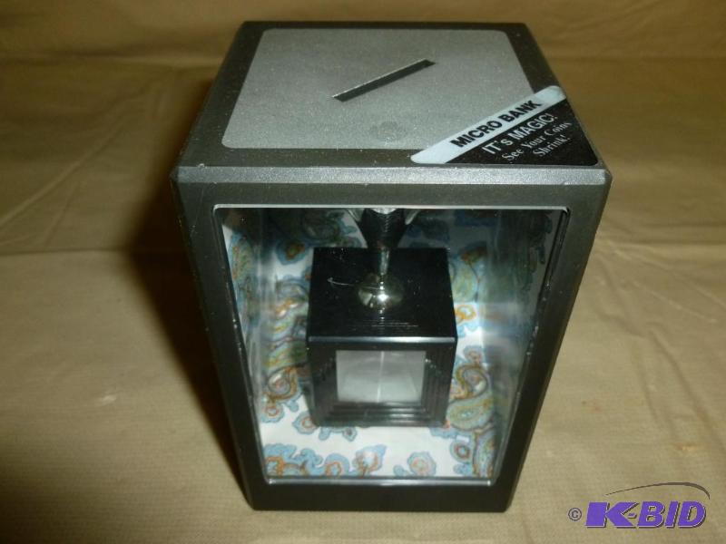 lot 197 image: Micro Coin Bank, looks like the coins shrink ...