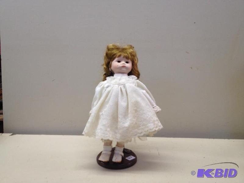 lot 83 image: Porcelain Doll...