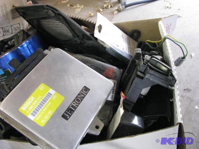 lot 166 image: Box full of car parts and Chevy car logo...