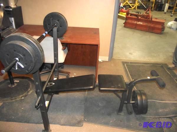 lot 83 image: Weight Bench   Includes some weights and bar ...