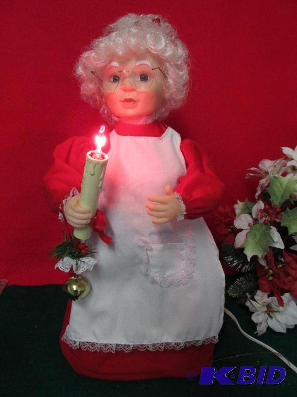 Mrs Santa holding a Candle - waves it back and forth