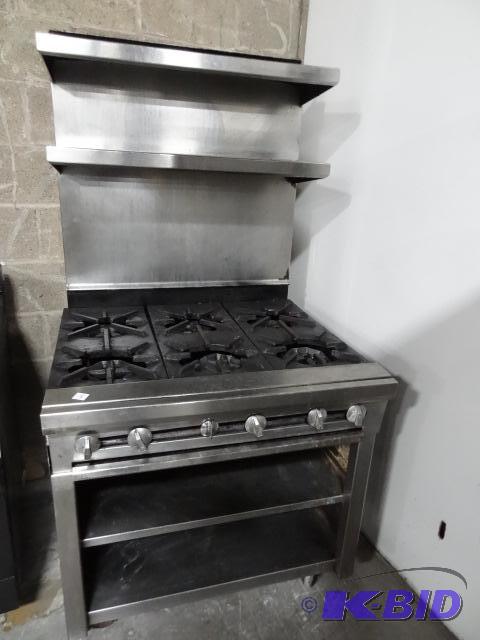 lot 79 image: 6 Burner Natural Gas Stove. On Wheels. Undern...