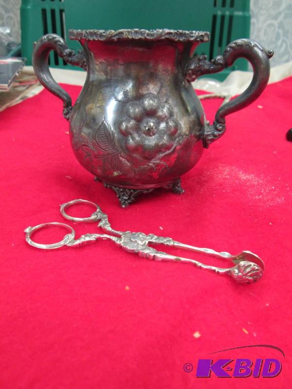 lot 13 image: Decorative tongs and a decorative thing to pu...
