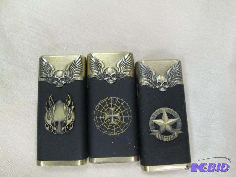 lot 213 image: Qty 3 Novelty lighter gold and black has a sk...