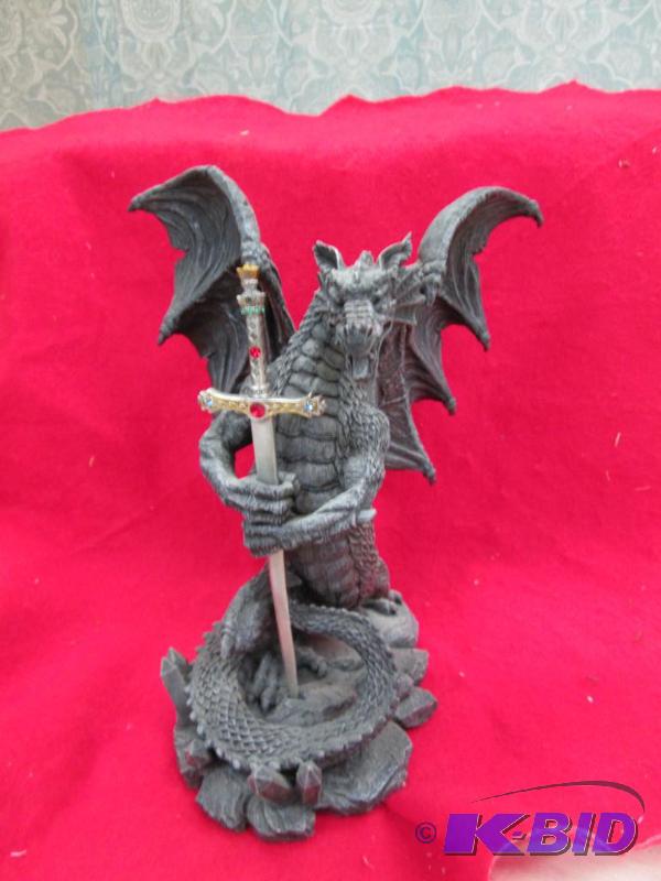 lot 51 image: A figurine of a dragon holden a sword...