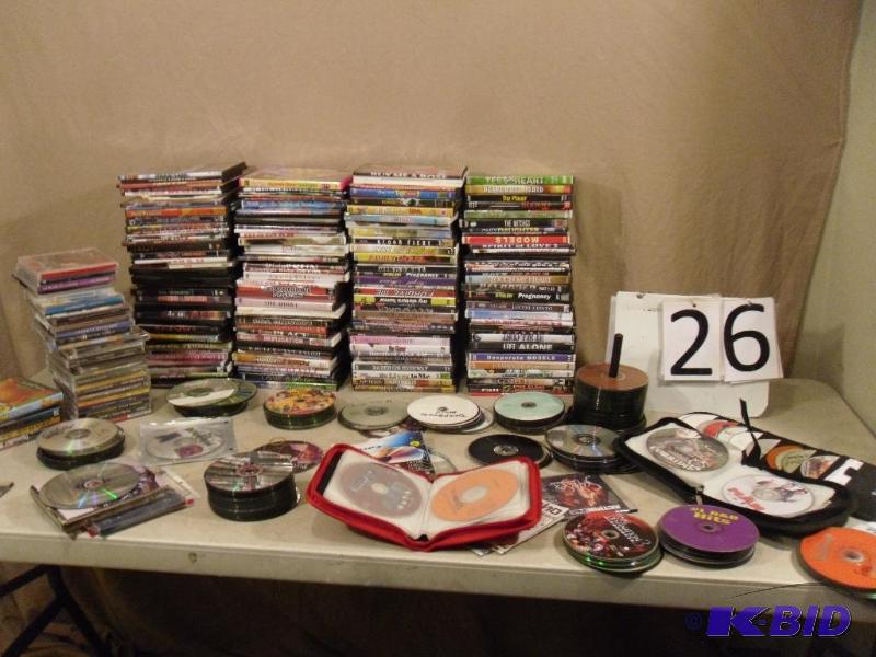 lot 26 image: Large Lot of Assorted DVDs and CDs. Most case...
