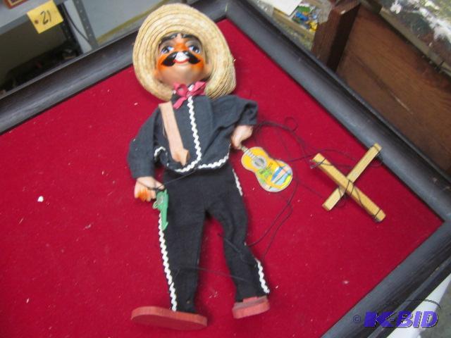 Mexican puppet on stings, holding gun and gui...