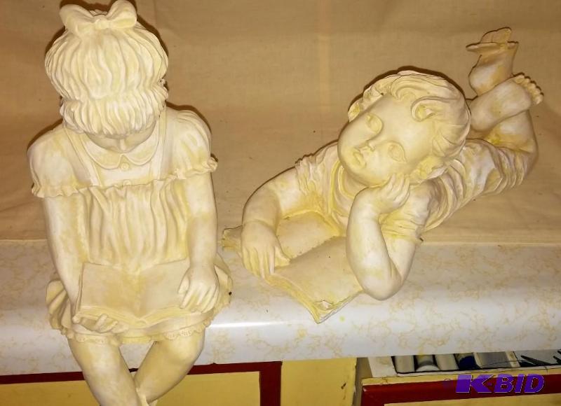 Lawn Statues of girl and boy reading...