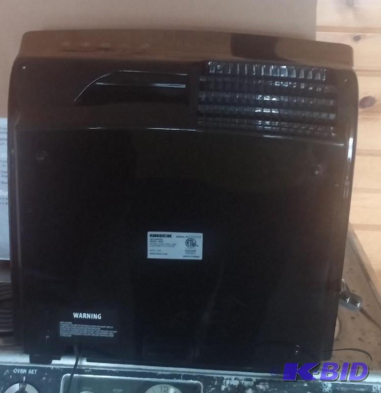 lot 15 image: Oreck Air Purifier, used. Works but needs a g...