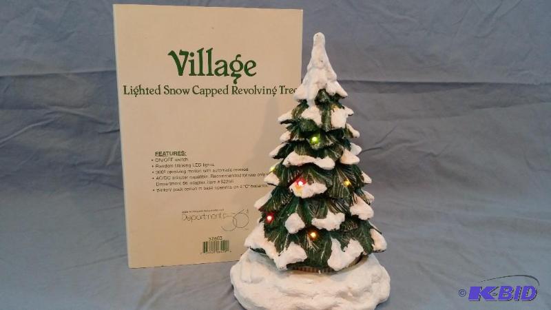 Village Lighted snow capped revolving tree