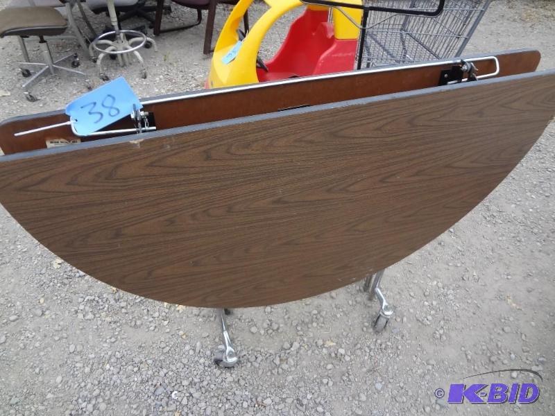 lot 38 image: Round Folding Table on Wheels