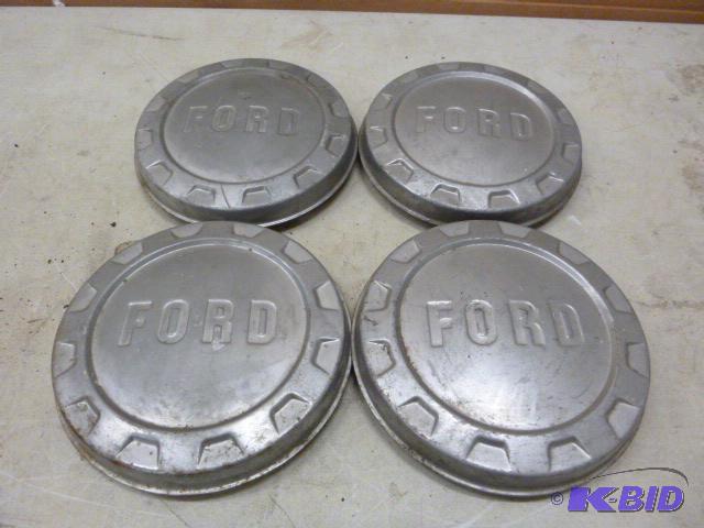 lot 180 image: Four Ford Hubcaps ...