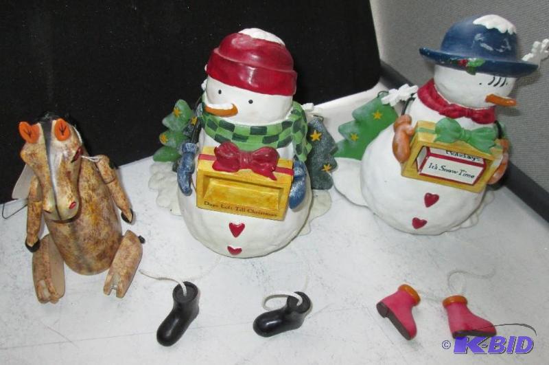 Pair of snowmen with hanging feet and a joint...
