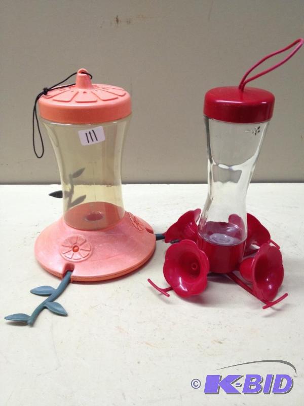 lot 111 image: 2 Hummingbird Feeders  One is Glass, One is P...