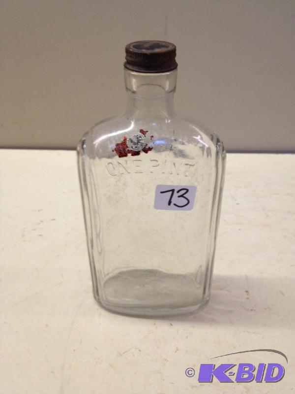 lot 73 image: Antique Liquor Bottle   Has remains of t...