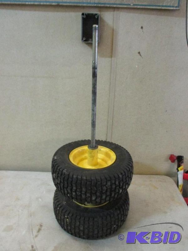 lot 52 image: mower axle with rims and tires, tires are new...